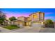 Beautiful two-story home with a three-car garage and meticulously kept front lawn at 18518 E Ashridge Dr, Queen Creek, AZ 85142