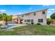 Two-story home with a pool, covered patio, and well-maintained lawn at 18518 E Ashridge Dr, Queen Creek, AZ 85142