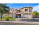 Inviting two-story home with a well-maintained lawn and attached three-car garage at 18518 E Ashridge Dr, Queen Creek, AZ 85142