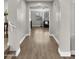 Inviting hallway with hardwood floors and a view of the living room at 18518 E Ashridge Dr, Queen Creek, AZ 85142