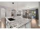 Spacious kitchen featuring granite counters, pendant lighting, stainless steel appliances and a view of the backyard through sliding glass doors at 18518 E Ashridge Dr, Queen Creek, AZ 85142