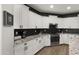 Modern kitchen showcasing sleek white cabinetry, stainless steel appliances, dark backsplash and beautiful countertops at 18518 E Ashridge Dr, Queen Creek, AZ 85142