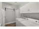 Well-equipped laundry room with washer, dryer, storage cabinets, and ample counter space at 18518 E Ashridge Dr, Queen Creek, AZ 85142