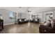 Spacious living room featuring hardwood floors, an electric fireplace, and comfortable leather furniture with great natural lighting at 18518 E Ashridge Dr, Queen Creek, AZ 85142