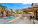 Covered patio offering a relaxing space next to the pool with ample seating and lighting at 18518 E Ashridge Dr, Queen Creek, AZ 85142