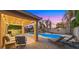Relaxing covered patio with cozy seating, overlooking the pool and backyard area at 18518 E Ashridge Dr, Queen Creek, AZ 85142