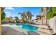 Sparkling pool with a waterfall feature, diving board, and lush landscaping at 18518 E Ashridge Dr, Queen Creek, AZ 85142