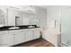 Bathroom featuring double sinks, granite countertops, a soaking tub, and a glass-enclosed shower at 20121 N 76Th St # 2058, Scottsdale, AZ 85255