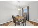 Warm dining room featuring a round table beneath a chandelier with natural light from a window at 20121 N 76Th St # 2058, Scottsdale, AZ 85255