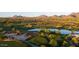 Aerial view of a lush golf course with water features and desert landscaping, backed by stunning mountain views at 20121 N 76Th St # 2058, Scottsdale, AZ 85255