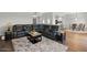 Comfortable living room with leather sectional, rug and an adjacent dining area at 20121 N 76Th St # 2058, Scottsdale, AZ 85255