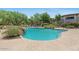 Beautiful community pool featuring lush landscaping, lounge chairs, and a refreshing water feature at 20121 N 76Th St # 2058, Scottsdale, AZ 85255