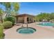 Outdoor spa and community pool with chairs and umbrellas, with a ramada for shade and relaxation at 20121 N 76Th St # 2058, Scottsdale, AZ 85255