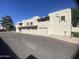 View of the home's exterior, highlighting the garages and architecture under a clear sky at 2020 W Union Hills Dr # 240, Phoenix, AZ 85027
