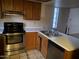 Kitchen showcasing wood cabinets, stainless steel appliances, and a double basin sink at 2020 W Union Hills Dr # 240, Phoenix, AZ 85027