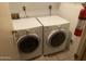 Laundry room with a side-by-side washer and dryer set and a fire extinguisher at 2020 W Union Hills Dr # 240, Phoenix, AZ 85027
