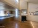 Bright living room featuring a fireplace, hardwood floors and view of the kitchen at 2020 W Union Hills Dr # 240, Phoenix, AZ 85027