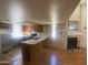 Bright open-concept living room featuring a fireplace, wood floors, and a kitchen with ample counter space at 2020 W Union Hills Dr # 240, Phoenix, AZ 85027