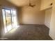 Spacious living room with high ceilings, a ceiling fan, and sliding glass doors leading to a balcony at 2020 W Union Hills Dr # 240, Phoenix, AZ 85027