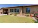 Exterior of house shows lawn, desert landscaping and covered patio at 20603 W Alsap Rd, Buckeye, AZ 85396