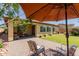 Relaxing backyard features a covered patio, lawn, and lush landscaping at 20603 W Alsap Rd, Buckeye, AZ 85396