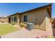 Exterior of house and landscaped yard with desert rock and air conditioner at 20603 W Alsap Rd, Buckeye, AZ 85396