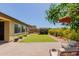 Charming backyard featuring a well-maintained lawn, beautiful flowering plants and a cozy seating area at 20603 W Alsap Rd, Buckeye, AZ 85396