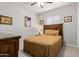 Comfortable bedroom showcasing a bed with goldenrod bedding, a ceiling fan, and soft carpet at 20603 W Alsap Rd, Buckeye, AZ 85396