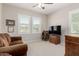 Cozy bedroom with dual windows, comfortable sofa, and TV area for relaxation at 20603 W Alsap Rd, Buckeye, AZ 85396