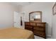 Comfortable bedroom featuring wood furniture, soft carpet, and bright natural light at 20603 W Alsap Rd, Buckeye, AZ 85396
