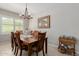 Elegant dining room with a traditional table set, chandelier, and a sunny window at 20603 W Alsap Rd, Buckeye, AZ 85396