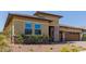 Beautiful exterior showcasing stone accents, mature landscaping, and a well-manicured front yard at 20603 W Alsap Rd, Buckeye, AZ 85396