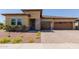 Charming single-story home showcasing a well-manicured lawn and inviting three-car garage at 20603 W Alsap Rd, Buckeye, AZ 85396