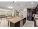 Open kitchen with granite island and stainless appliances seamlessly connected to the dining and living areas at 20603 W Alsap Rd, Buckeye, AZ 85396