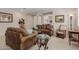 Inviting living room featuring brown leather sofas, glass tables, and neutral decor at 20603 W Alsap Rd, Buckeye, AZ 85396
