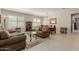 Spacious living area flows into the dining room, complemented by large windows and neutral tones at 20603 W Alsap Rd, Buckeye, AZ 85396