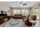 Inviting living room features plush seating, a ceiling fan, and abundant natural light at 20603 W Alsap Rd, Buckeye, AZ 85396