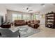 Inviting living room features plush seating, a ceiling fan, and abundant natural light at 20603 W Alsap Rd, Buckeye, AZ 85396