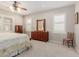 Main bedroom with shuttered windows, carpet flooring, and solid-wood furniture at 20603 W Alsap Rd, Buckeye, AZ 85396