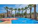 Community splash pad with multiple water features, palm trees, and colorful play surfaces at 20603 W Alsap Rd, Buckeye, AZ 85396
