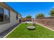 Spacious backyard featuring artificial grass, a wooden sauna, and block fence for privacy at 21824 S 226Th Pl, Queen Creek, AZ 85142