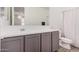 Stylish bathroom featuring modern gray vanity, white sink, and shower with curtain at 21824 S 226Th Pl, Queen Creek, AZ 85142