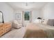 Bright bedroom features a dresser, a comfortable armchair, and neutral decor at 21824 S 226Th Pl, Queen Creek, AZ 85142
