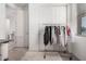 Walk-in closet featuring neutral walls, sliding doors, and a clothing rack at 21824 S 226Th Pl, Queen Creek, AZ 85142