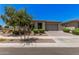 Attractive one-story home featuring desert landscaping, and a spacious driveway at 21824 S 226Th Pl, Queen Creek, AZ 85142