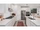 Well-lit kitchen showcasing stainless steel appliances, gas cooktop, and a spacious quartz countertop at 21824 S 226Th Pl, Queen Creek, AZ 85142
