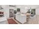 Open-concept kitchen with stainless steel appliances, island, dining area, and adjacent living space at 21824 S 226Th Pl, Queen Creek, AZ 85142