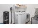 Laundry room featuring modern appliances and built-in shelving at 21824 S 226Th Pl, Queen Creek, AZ 85142
