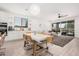 Open-concept living and dining area featuring modern lighting and a seamless flow at 21824 S 226Th Pl, Queen Creek, AZ 85142