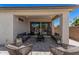 Comfortable covered patio with elegant stone flooring and refined outdoor seating at 21824 S 226Th Pl, Queen Creek, AZ 85142
